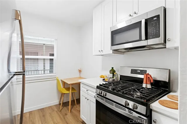 a bedroom with a bed couch and flat screen tv