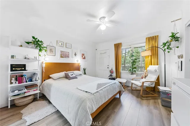 a bedroom with a bed furniture and flat screen tv