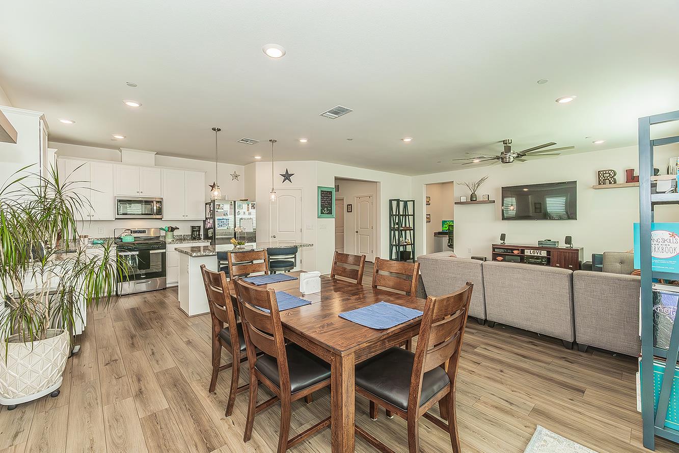644 Rock Crest Avenue Madera, CA 93636 - Photo 12 of 38 a view of a dining room with furniture and wooden floor