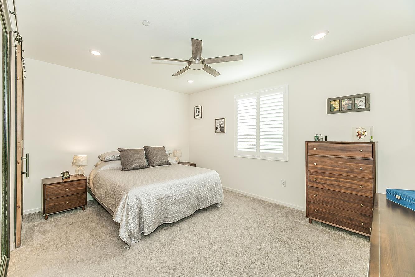 644 Rock Crest Avenue Madera, CA 93636 - Photo 18 of 38 a bedroom with a bed and a ceiling fan