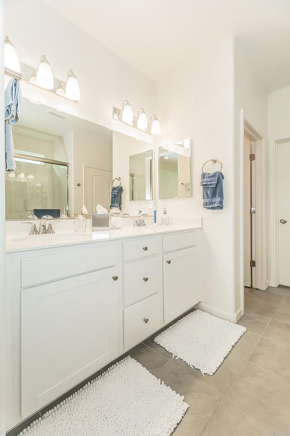 644 Rock Crest Avenue Madera, CA 93636 - Photo 21 of 38 a spacious bathroom with a double vanity sink mirror and