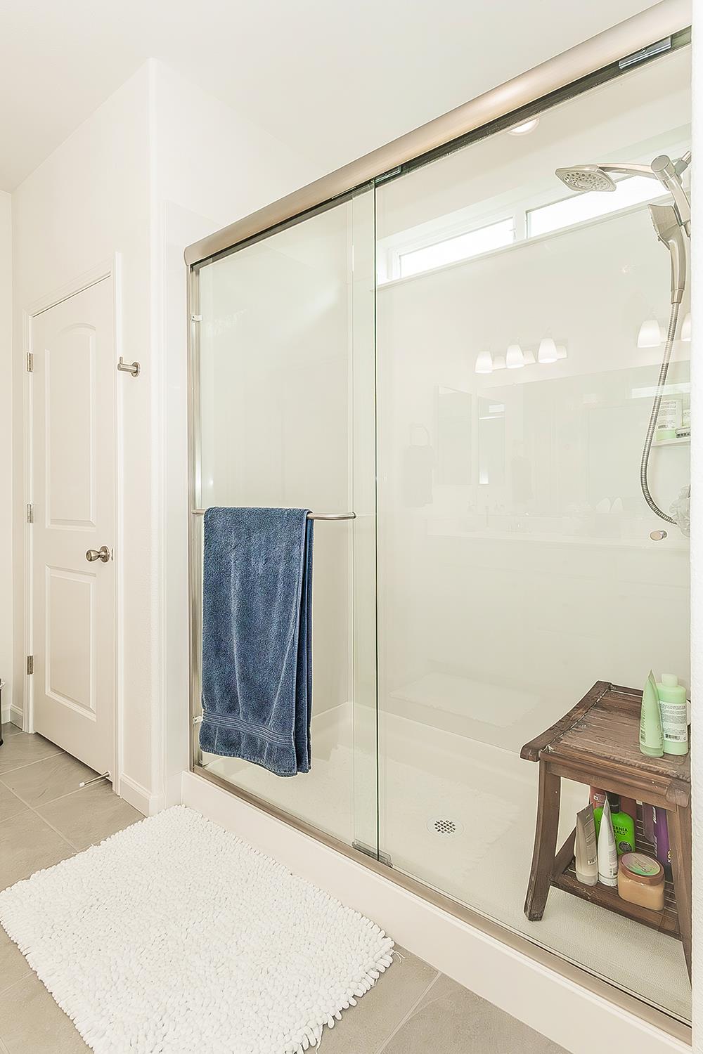644 Rock Crest Avenue Madera, CA 93636 - Photo 22 of 38 a bathroom with a glass shower door