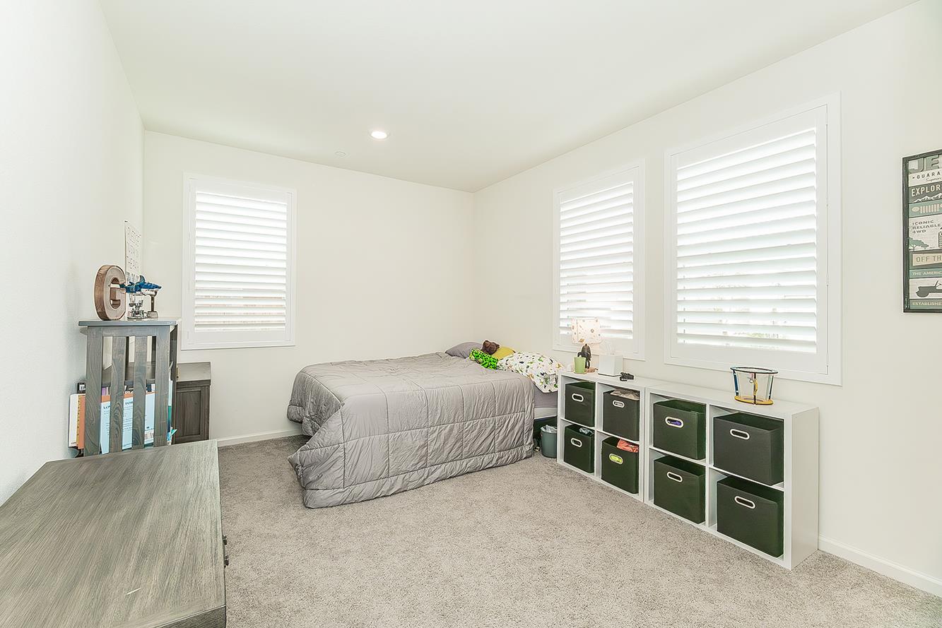 644 Rock Crest Avenue Madera, CA 93636 - Photo 23 of 38 a bedroom with a bed and a window