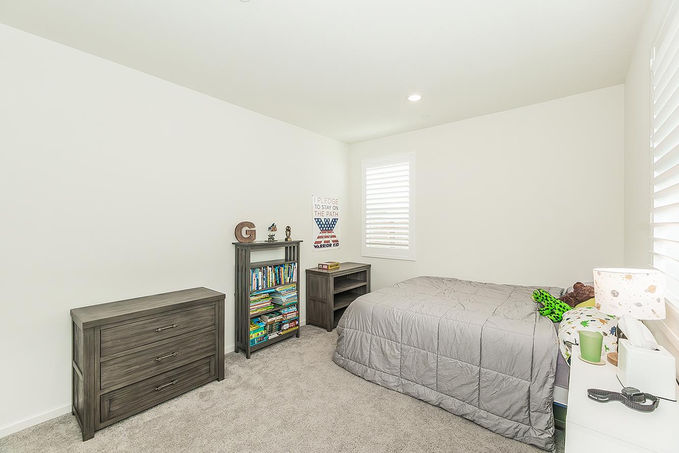 644 Rock Crest Avenue Madera, CA 93636 - Photo 24 of 38 a bedroom with a bed and a window