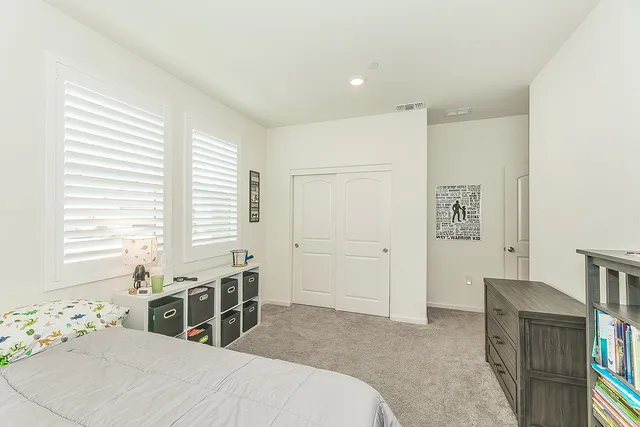 a bedroom with furniture and window