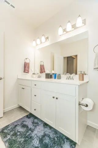 a bathroom with a sink vanity and mirror