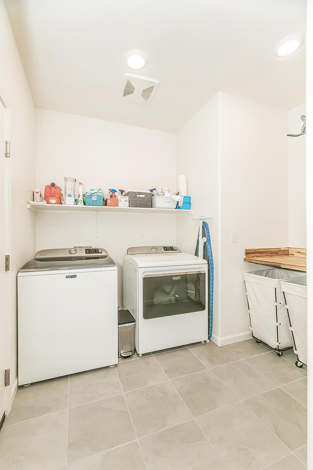 644 Rock Crest Avenue Madera, CA 93636 - Photo 30 of 38 a utility room with stainless steel appliances wooden floor and white cabinets