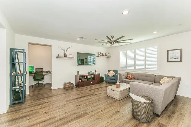 a living room with furniture and wooden floor