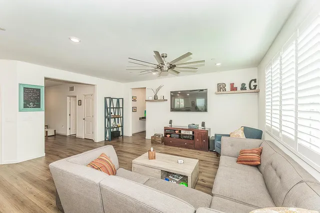 a living room with furniture and window with wooden floor