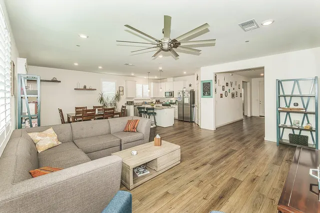 a living room with furniture and a wooden floor