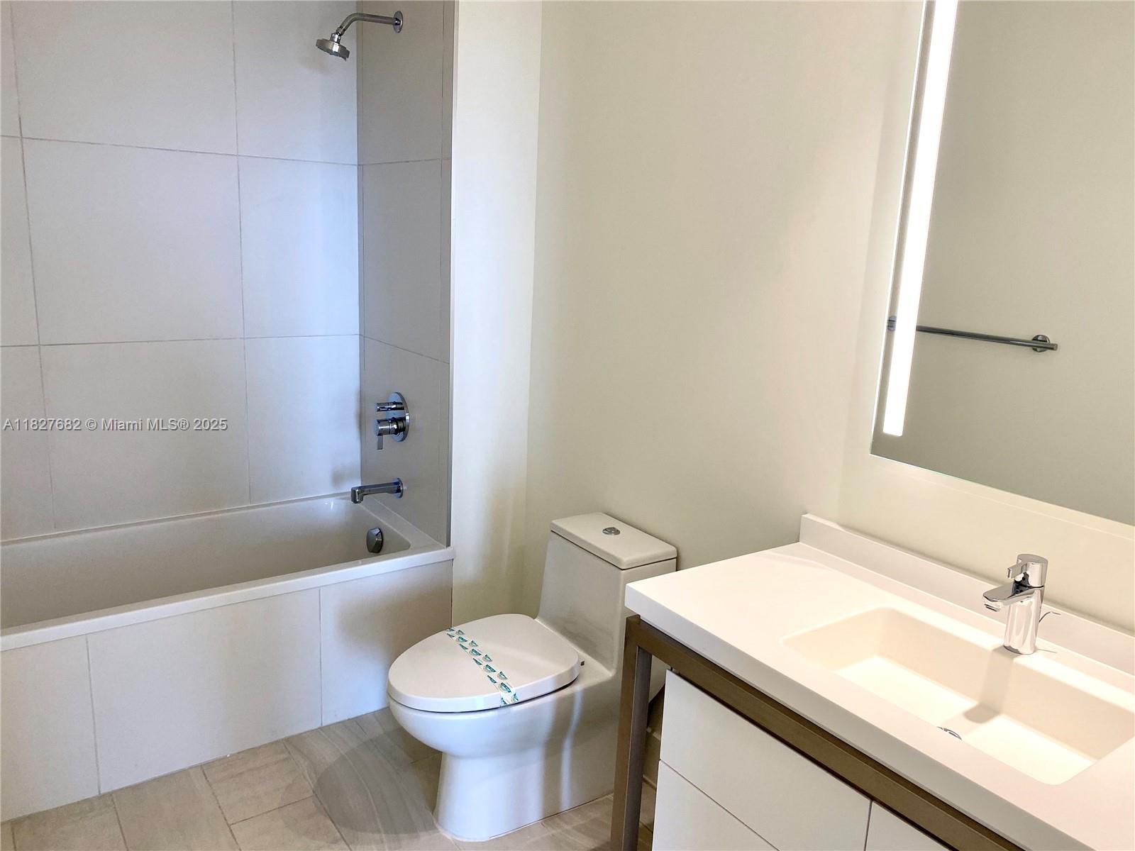 2000 Metropica Way, Unit 1605 Sunrise, FL 33323 - Photo 43 of 43 a bathroom with a sink a toilet and bathtub