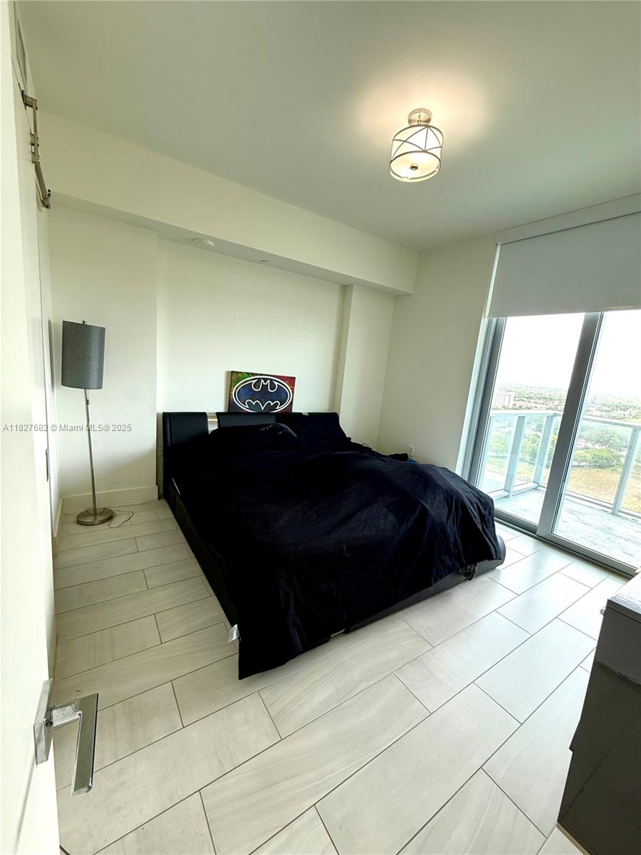 2000 Metropica Way, Unit 1605 Sunrise, FL 33323 - Photo 6 of 43 a bedroom with a bed and a double vanity