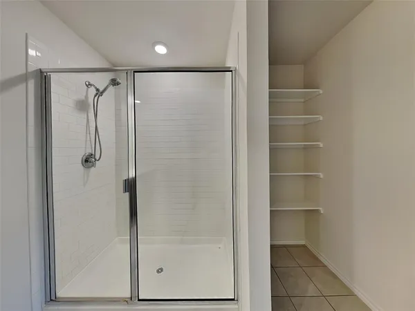 a bathroom with a glass shower door