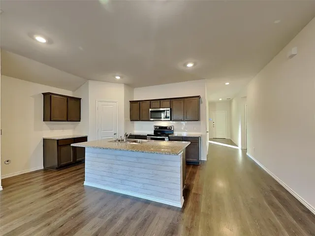 a kitchen with a stove a sink and a refrigerator