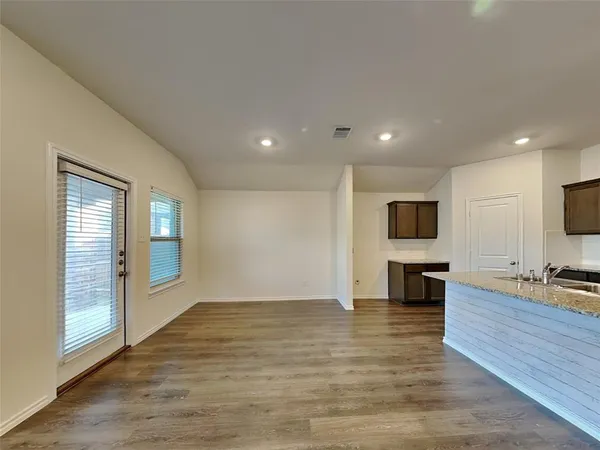 a view of kitchen with microwave refrigerator and furniture