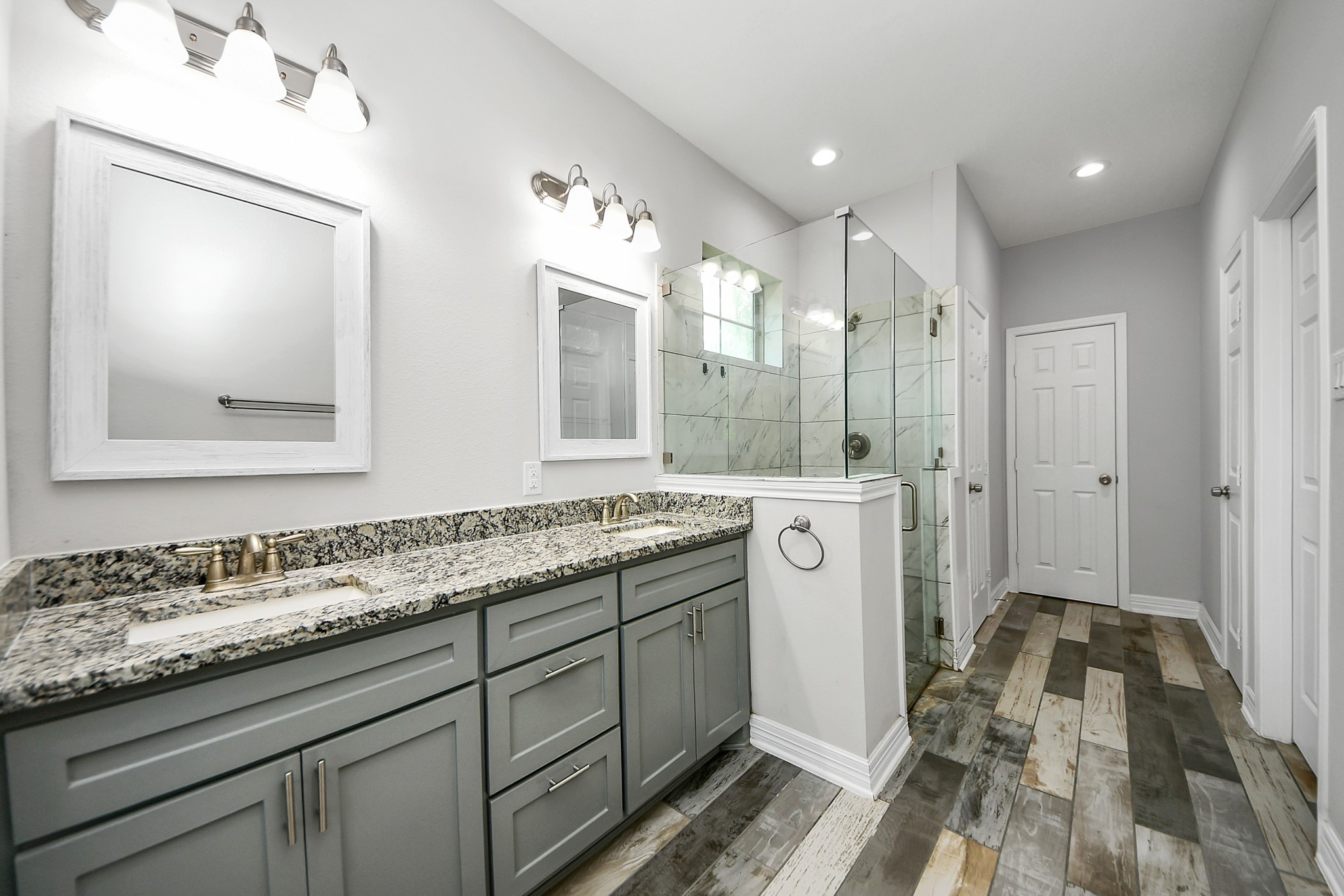 25450 Killarney Road Hempstead, TX 77445 - Photo 13 of 34 a bathroom with a double vanity sink and mirror