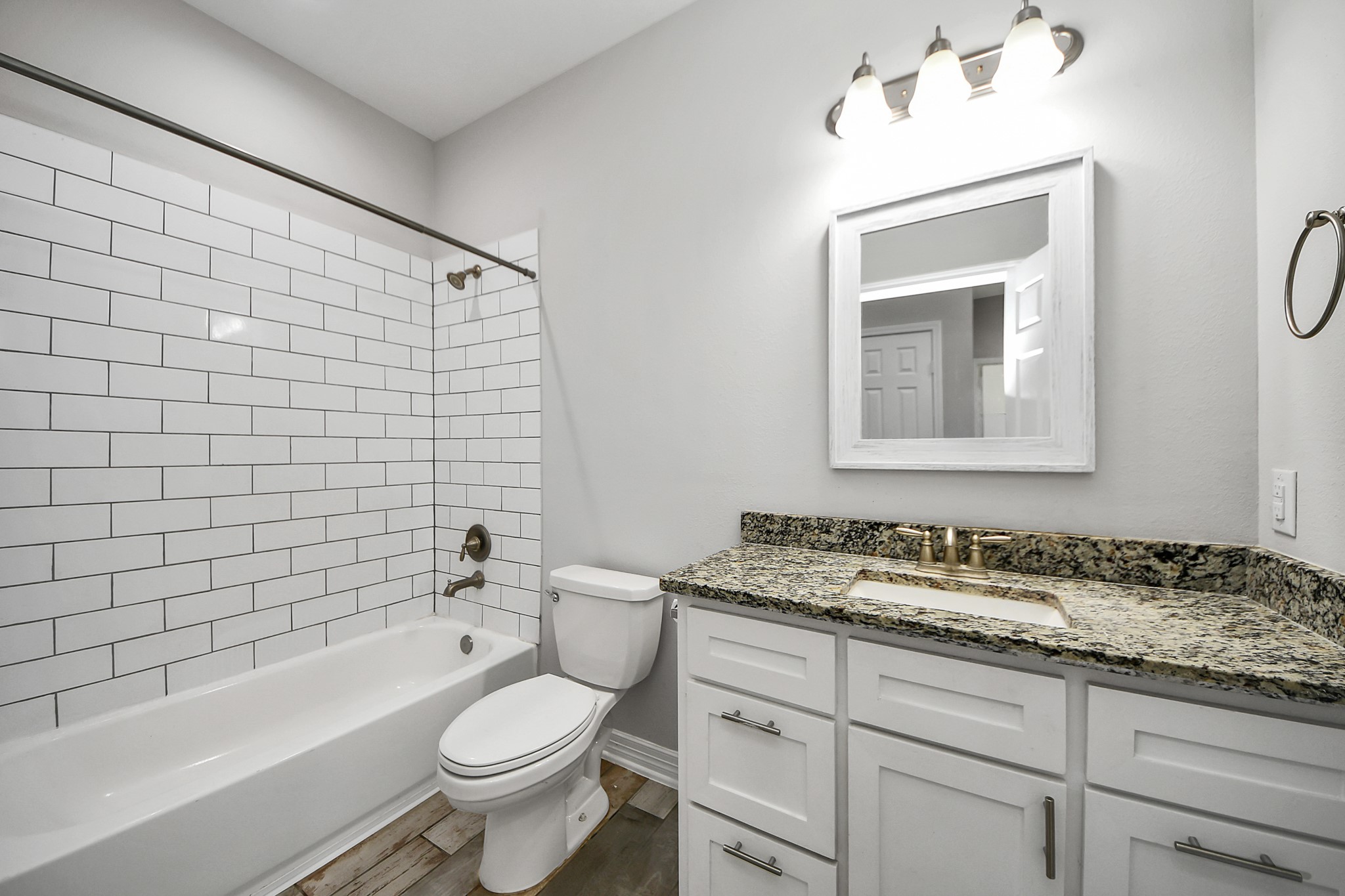 25450 Killarney Road Hempstead, TX 77445 - Photo 18 of 34 a bathroom with a granite countertop toilet a sink and bathtub