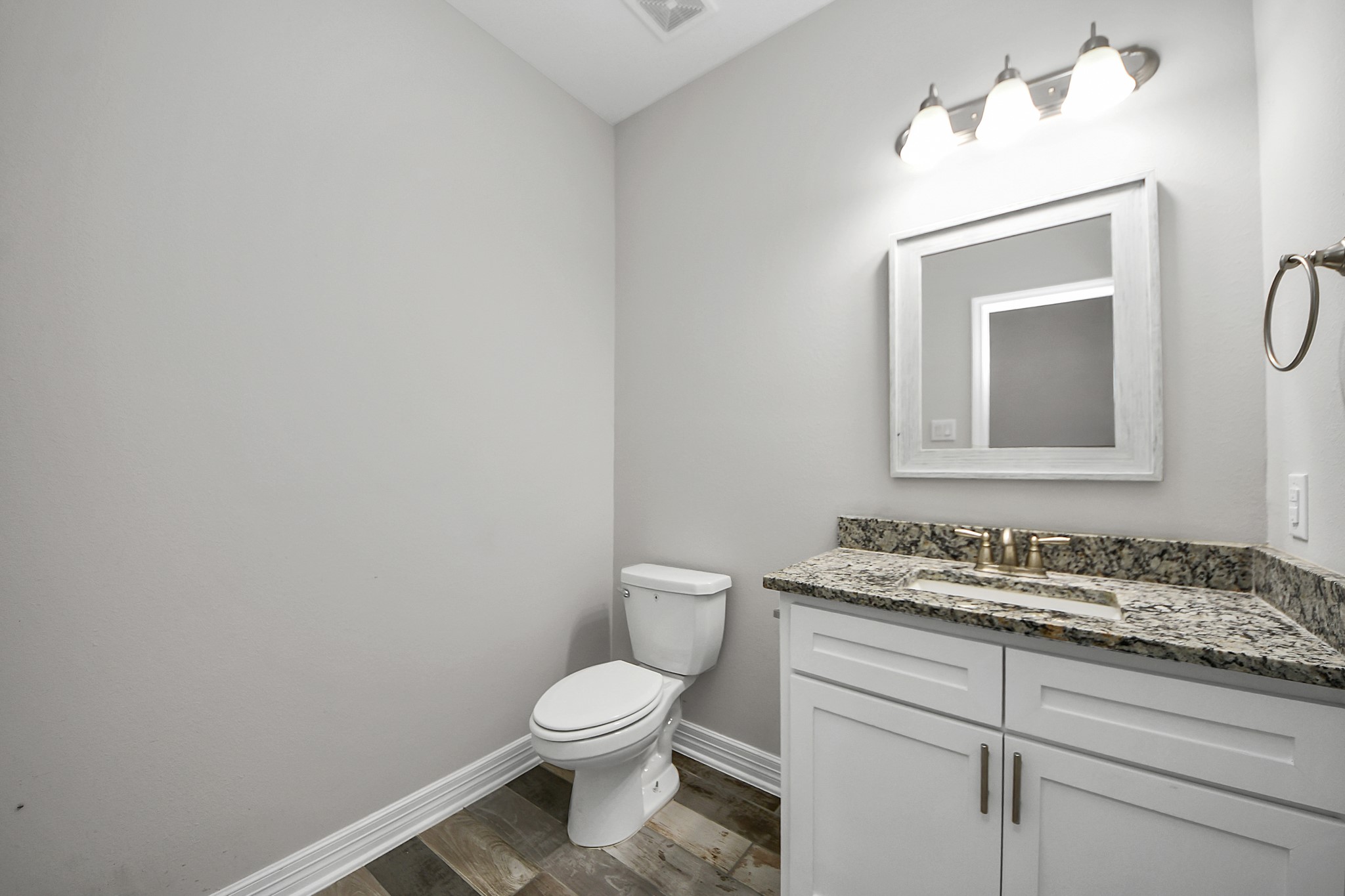 25450 Killarney Road Hempstead, TX 77445 - Photo 4 of 34 a bathroom with a toilet sink vanity and mirror