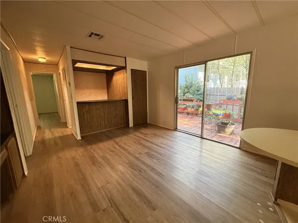 a living room with wooden floor and furniture