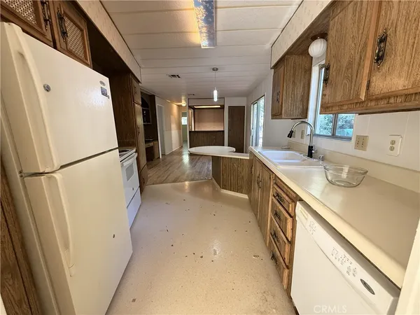 a view of a hallway with wooden floor and a living room