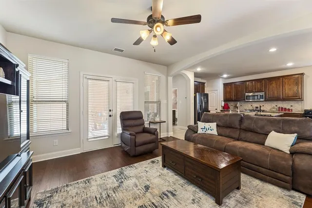 a kitchen with stainless steel appliances granite countertop a sink a stove and a refrigerator