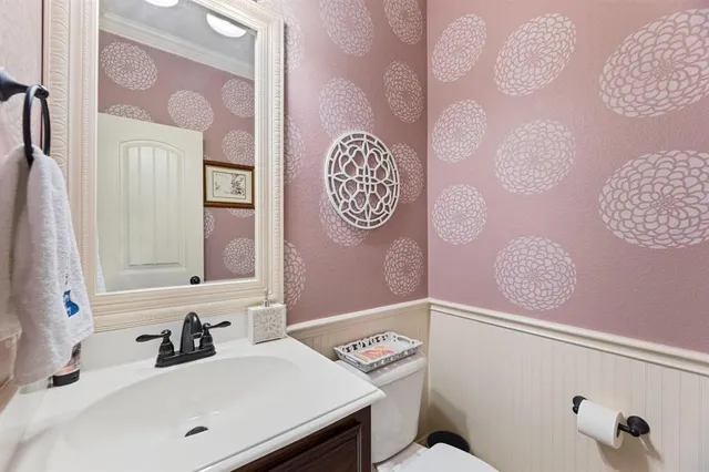 a spacious bedroom that has a bed and a chandelier