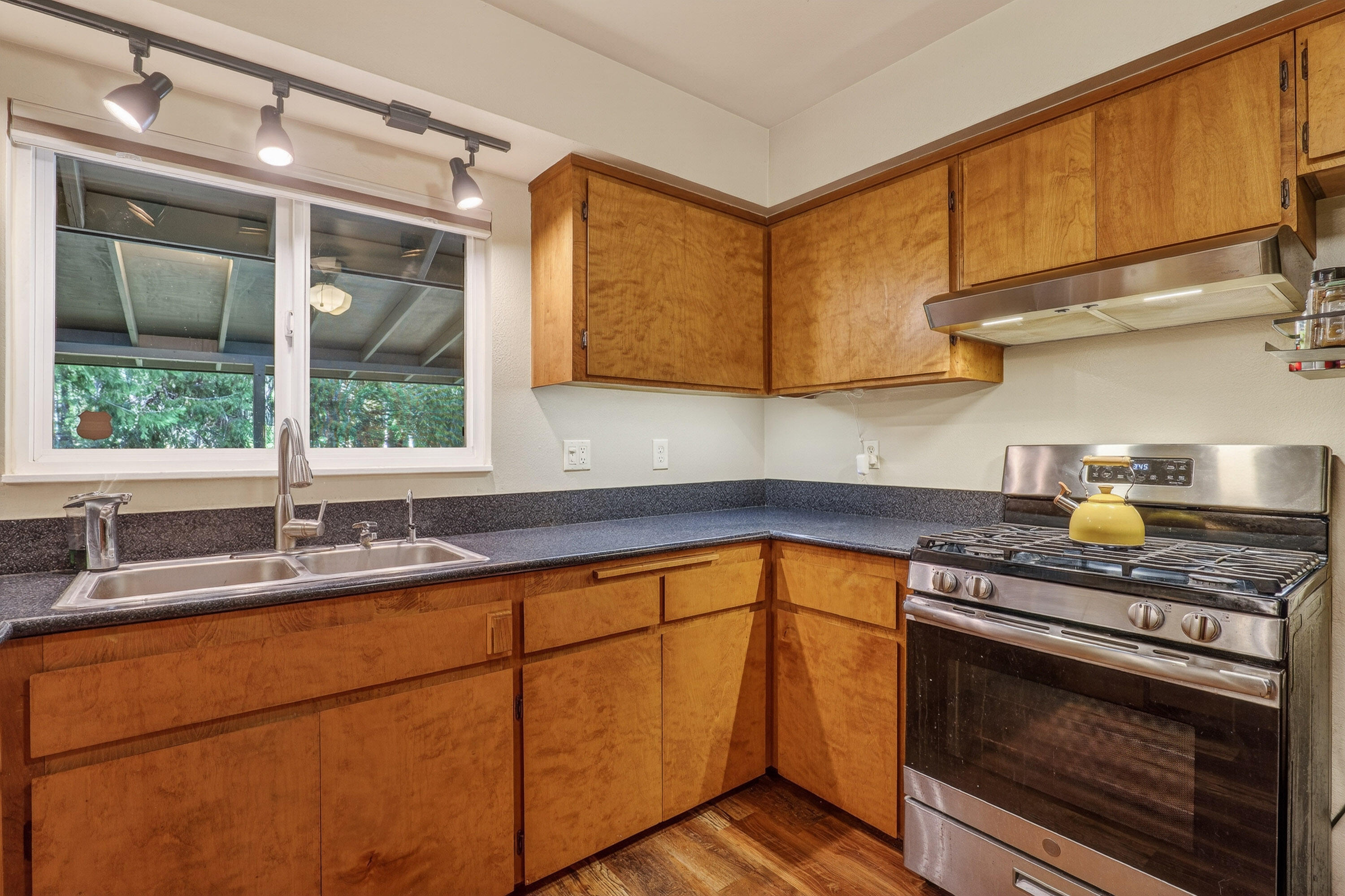 244 Riessen Road Grants Pass, OR 97526 - Photo 13 of 52 a kitchen with stainless steel appliances granite countertop a sink stove and cabinets