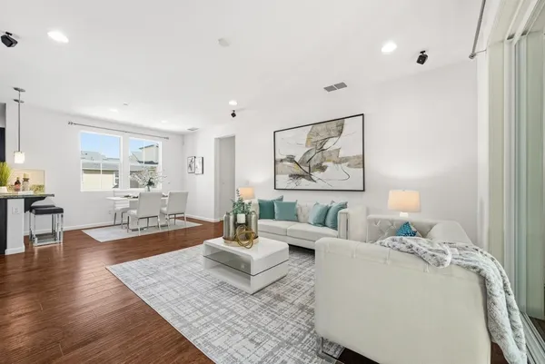a living room with furniture and a painting on the wall
