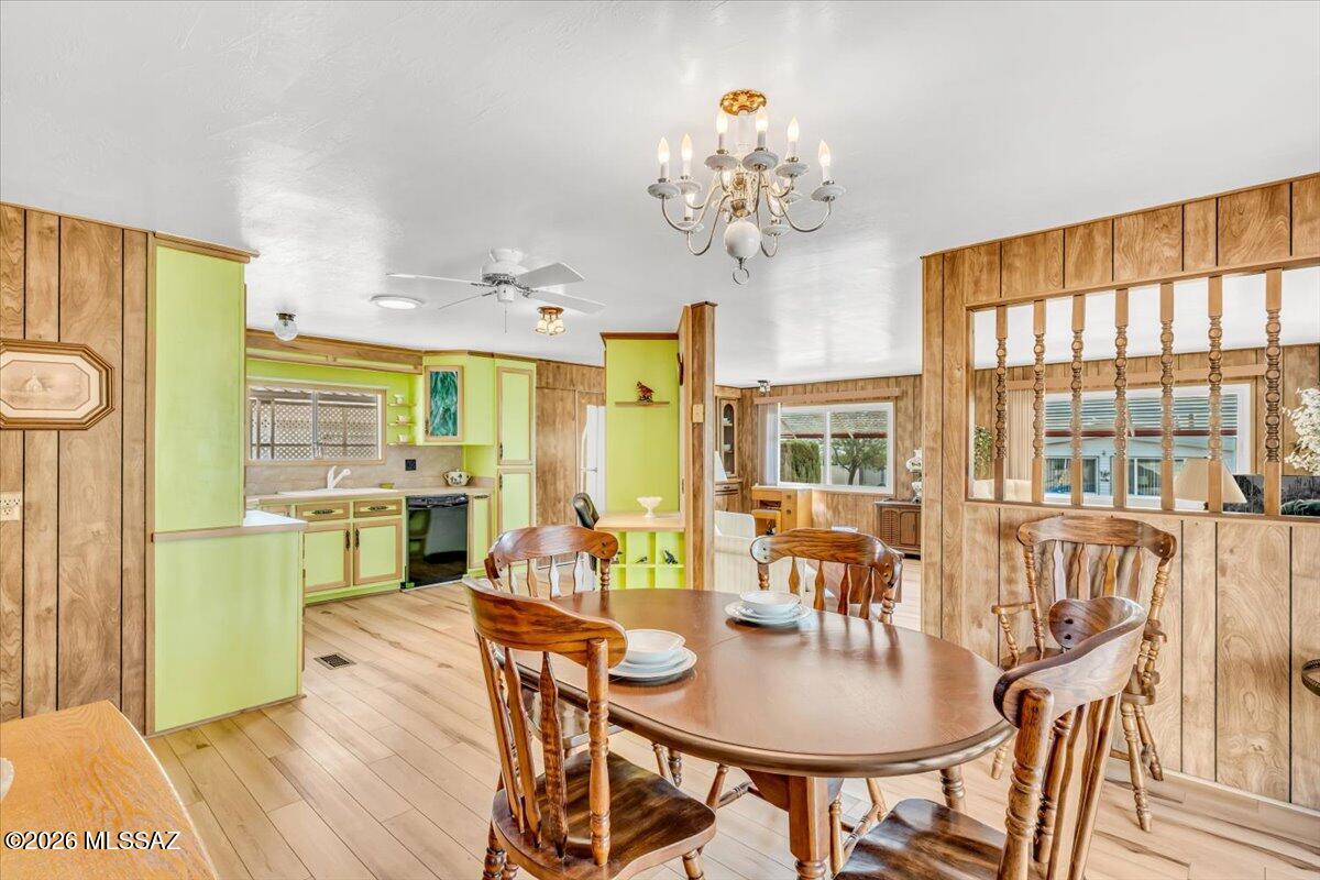 5840 West Flying W Street Tucson, AZ 85713 - Photo 4 of 38 a dining room with furniture a large window and wooden floor