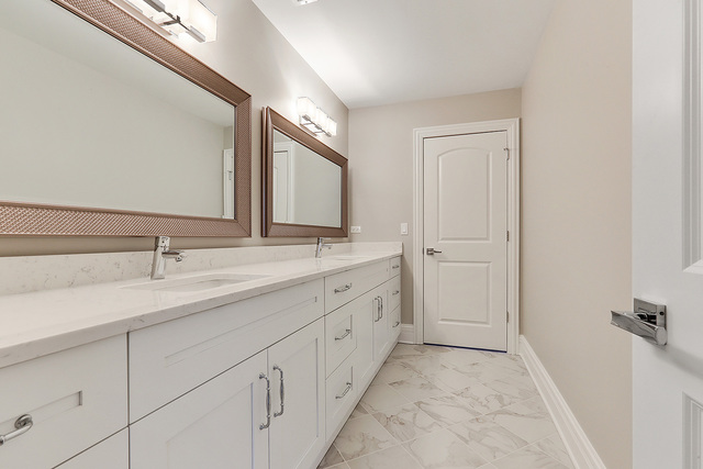 1851 Beechnut Road Northbrook, IL 60062 - Photo 25 of 40 a spacious bathroom with a double vanity sink and mirror