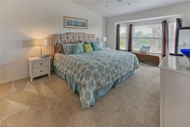 a bed room with a bed and a large window