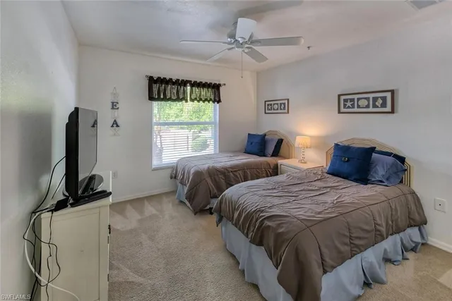 a bedroom with two beds and a window