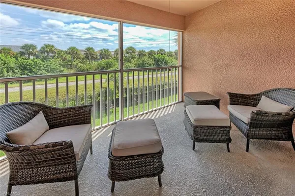 a balcony with furniture and a potted plant