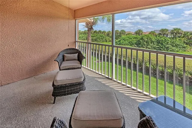 a balcony with chairs and a table