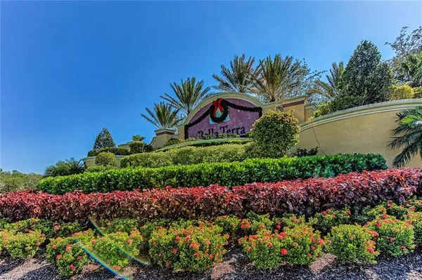 a sign that is in front of flowers