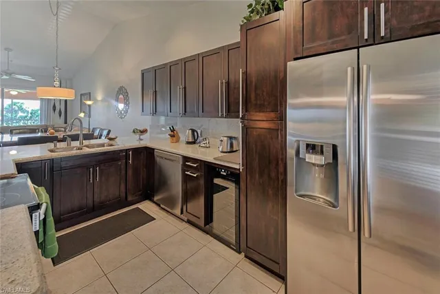 a kitchen with stainless steel appliances granite countertop a refrigerator and a sink