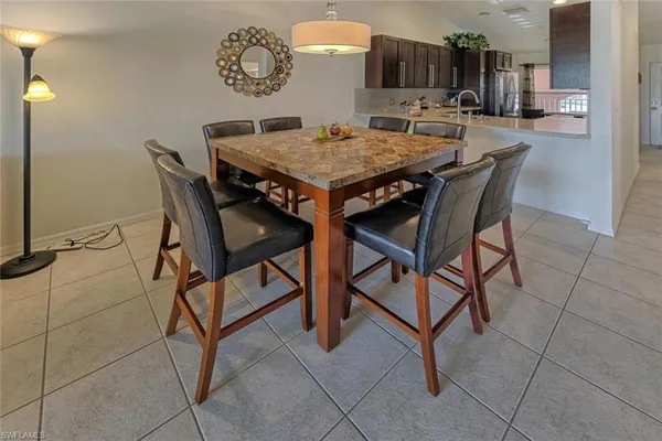 a dinning table and chairs in a kitchen