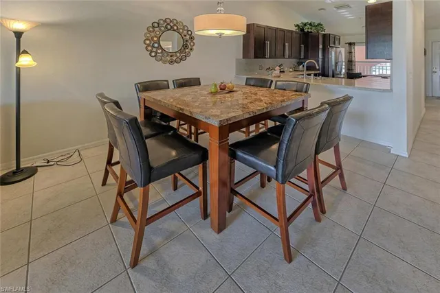 a dinning table and chairs in a kitchen