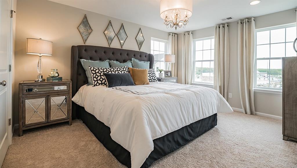 1405 Hights Farm Road South Raleigh, NC 27603 - Photo 3 of 25 a bed room with a bed and a chandelier
