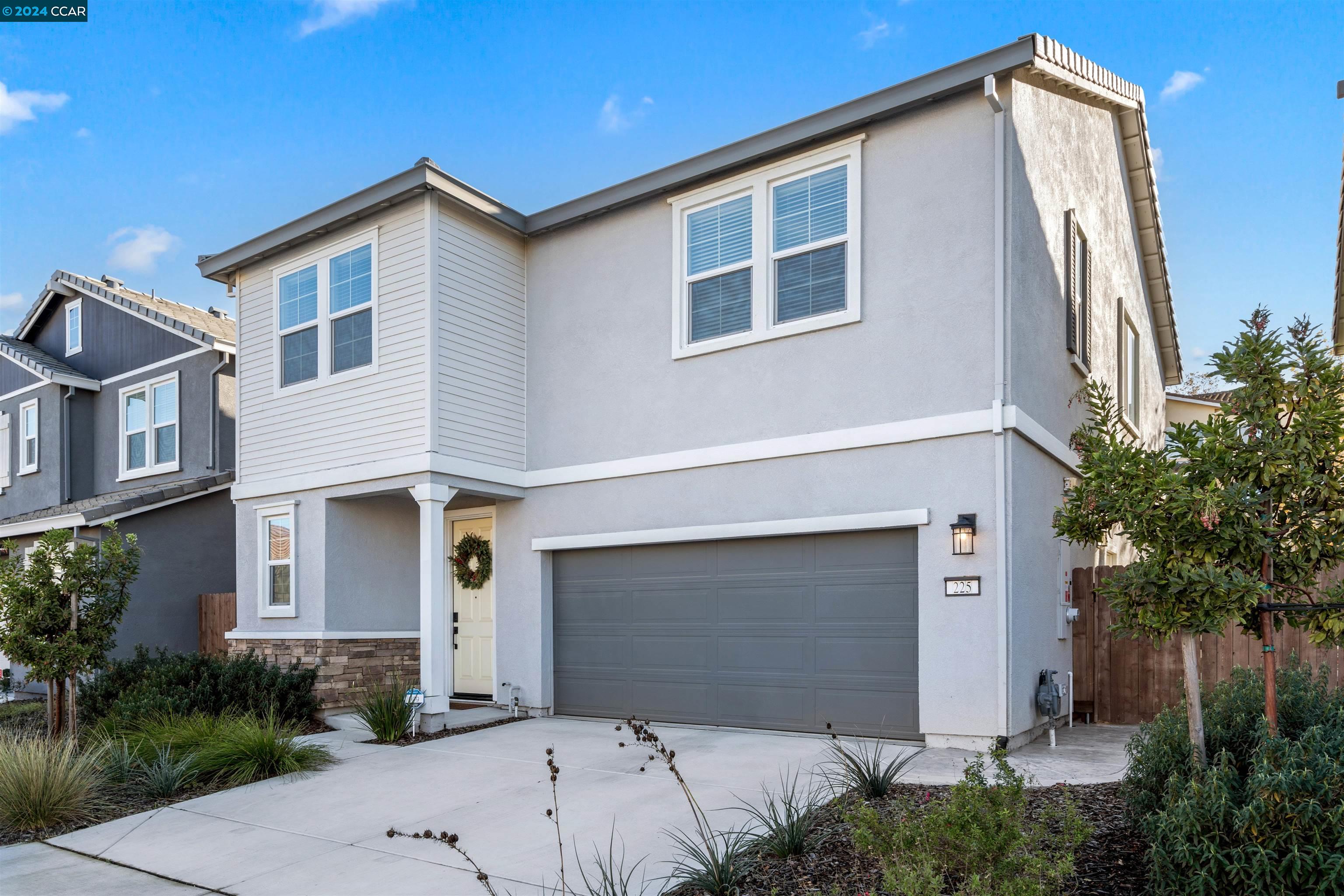a front view of a house with garage