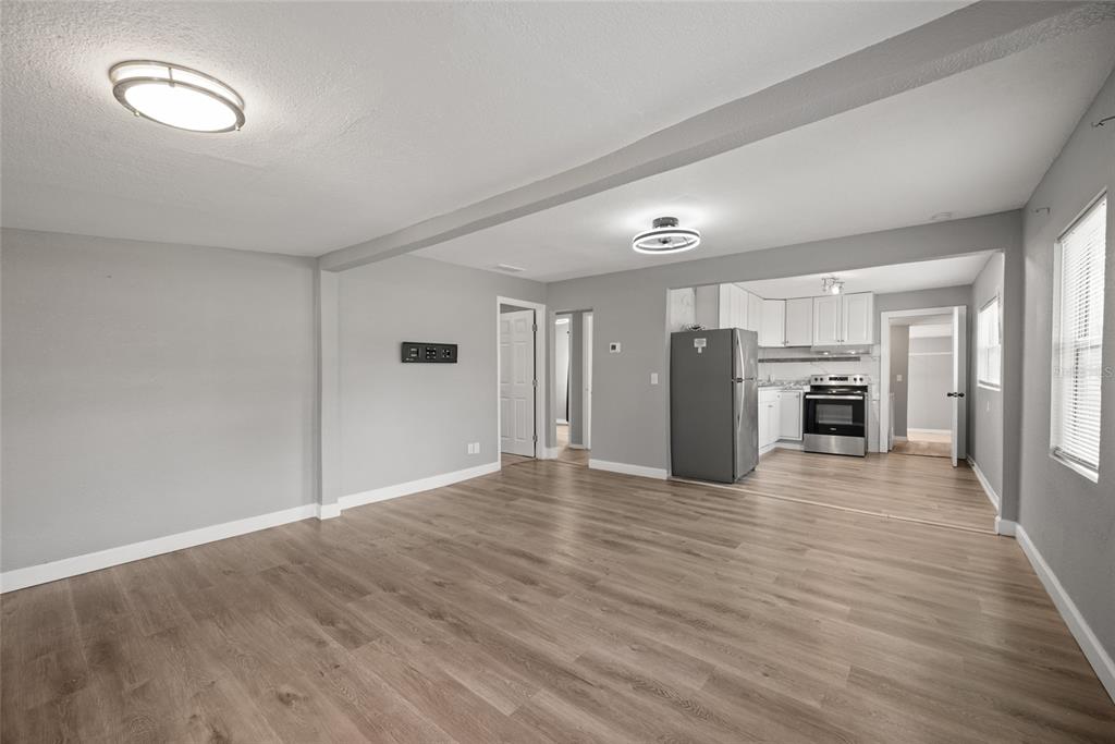 605 South Disston Avenue Tarpon Springs, FL 34689 - Photo 11 of 47 a view of a kitchen with wooden floor and an empty space