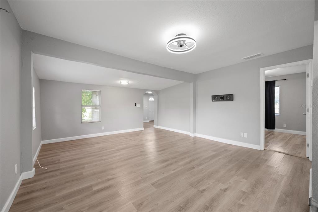 605 South Disston Avenue Tarpon Springs, FL 34689 - Photo 12 of 47 an empty room with wooden floor and windows