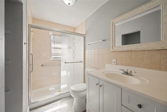 a bathroom with a sink toilet and shower
