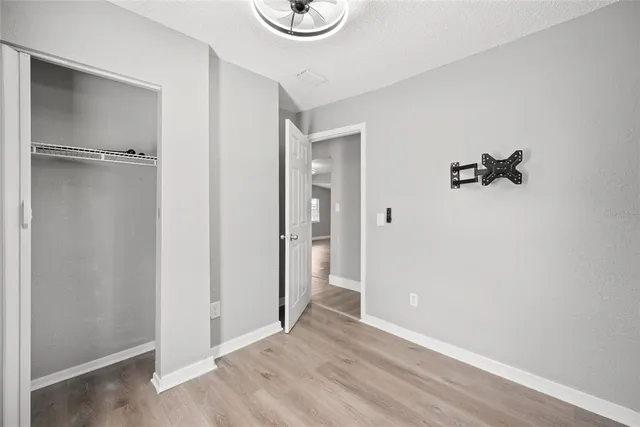 a view of an empty room with wooden floor