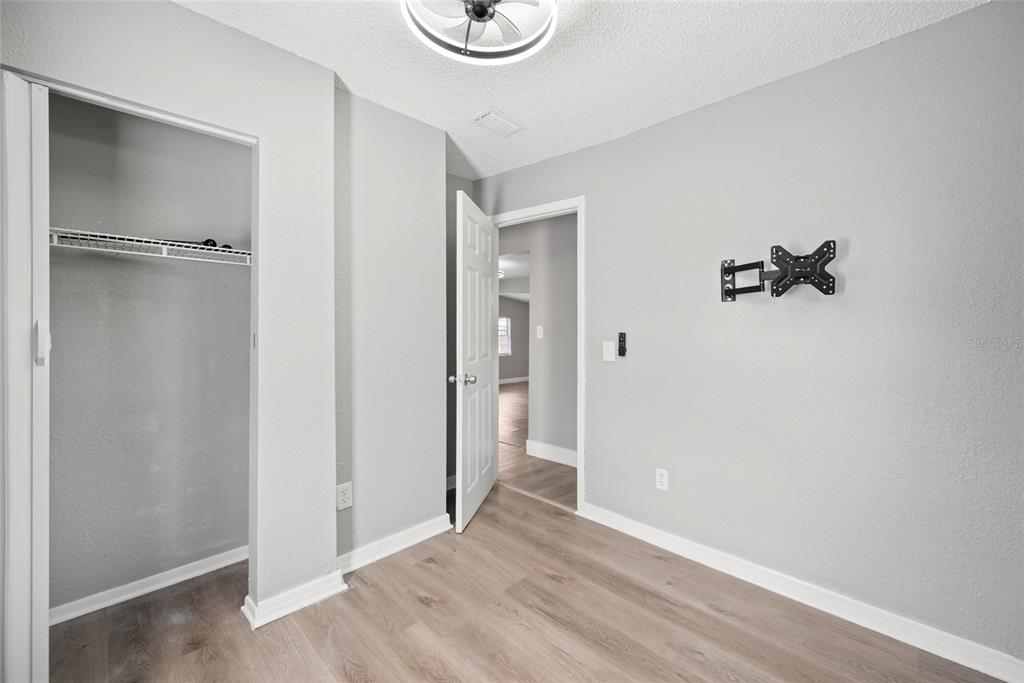 605 South Disston Avenue Tarpon Springs, FL 34689 - Photo 17 of 47 a view of an empty room with wooden floor