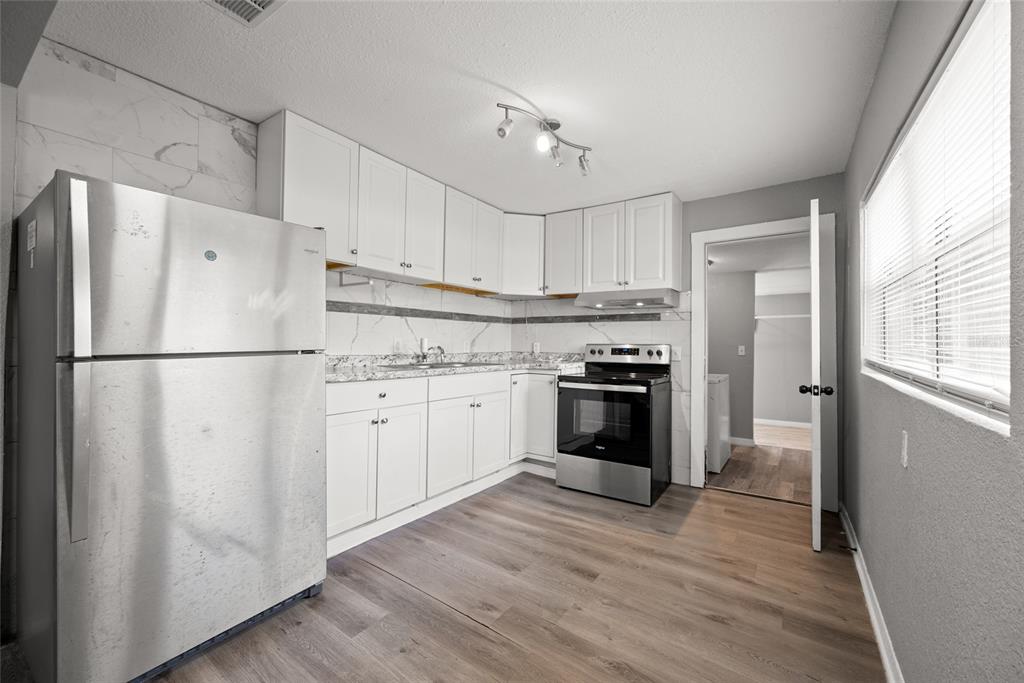 605 South Disston Avenue Tarpon Springs, FL 34689 - Photo 18 of 47 a kitchen with cabinets stainless steel appliances and wooden floor
