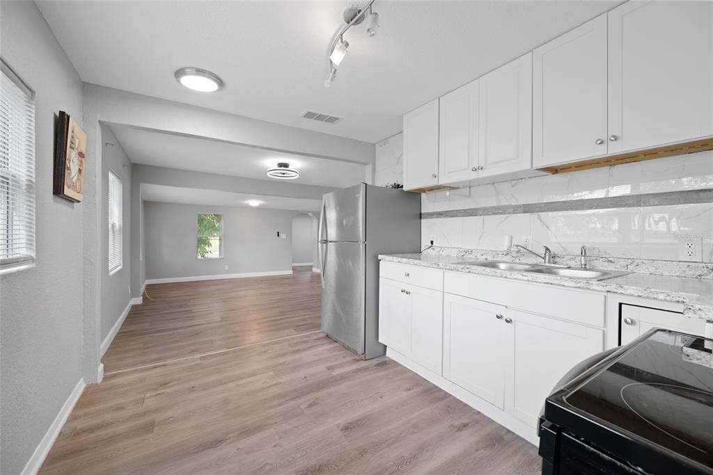 605 South Disston Avenue Tarpon Springs, FL 34689 - Photo 19 of 47 a view of a kitchen cabinets and wooden floor