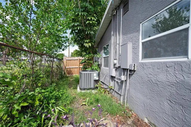 a backyard of a house with table and chairs