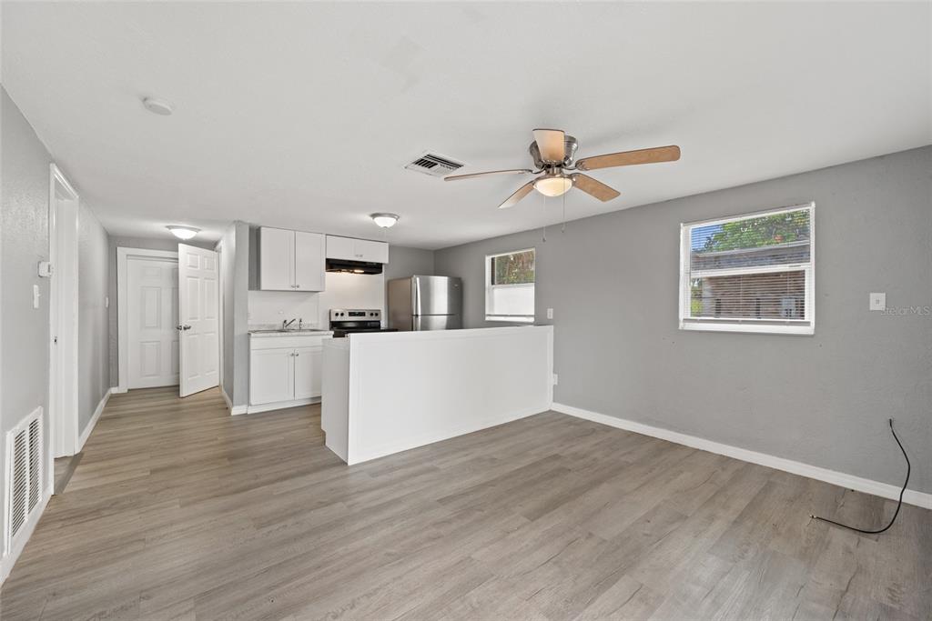 605 South Disston Avenue Tarpon Springs, FL 34689 - Photo 29 of 47 a view of a kitchen with wooden floor and a ceiling fan