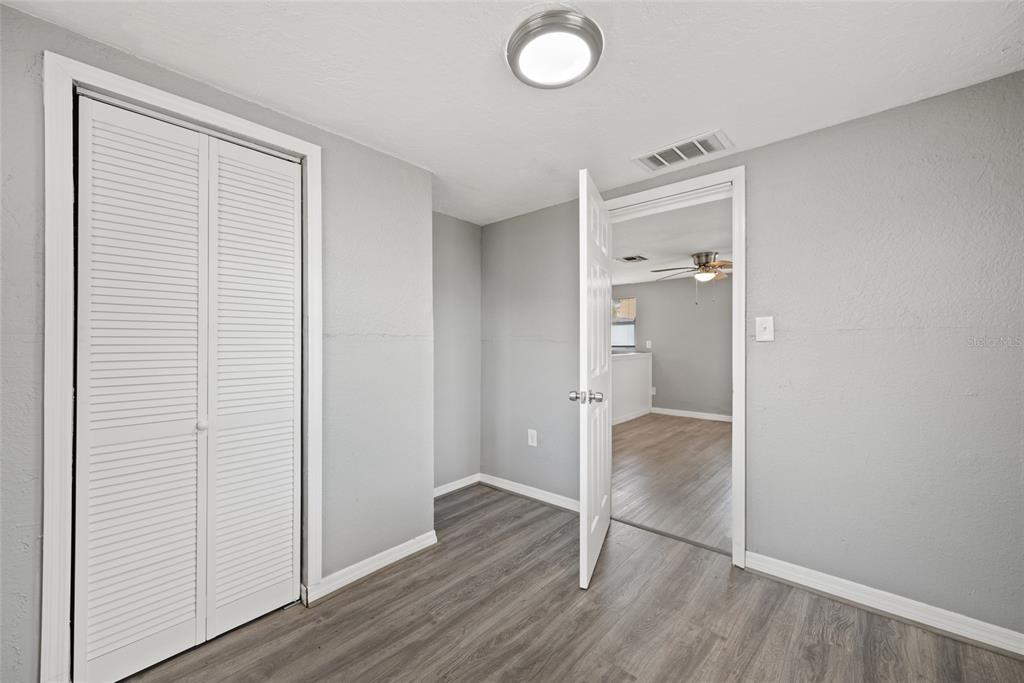 605 South Disston Avenue Tarpon Springs, FL 34689 - Photo 32 of 47 an empty room with wooden floor & bathroom